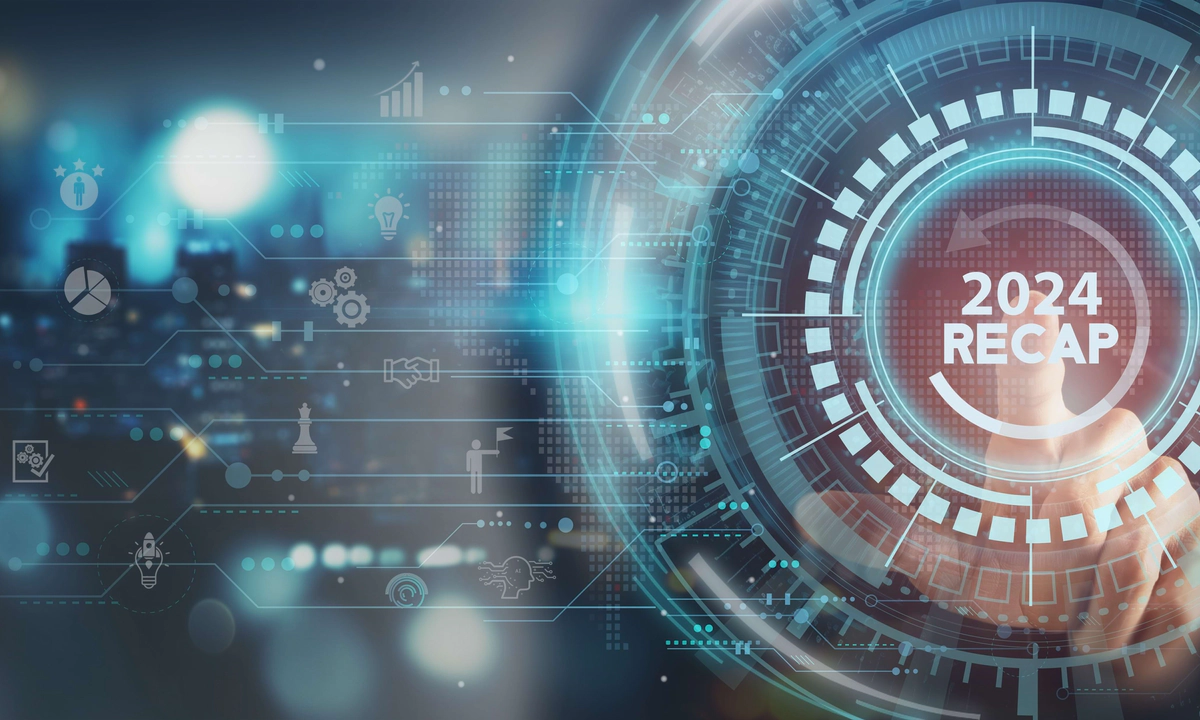 Graphic of a 2024 Recap button with a hand seen behind this with index finger pointing towards the text. White font. The heading is surrounded by a circular arrow, blue circles, lines, icons and geometric shapes.