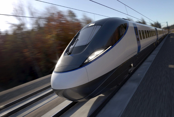 A commercial passenger train in motion on a train track.