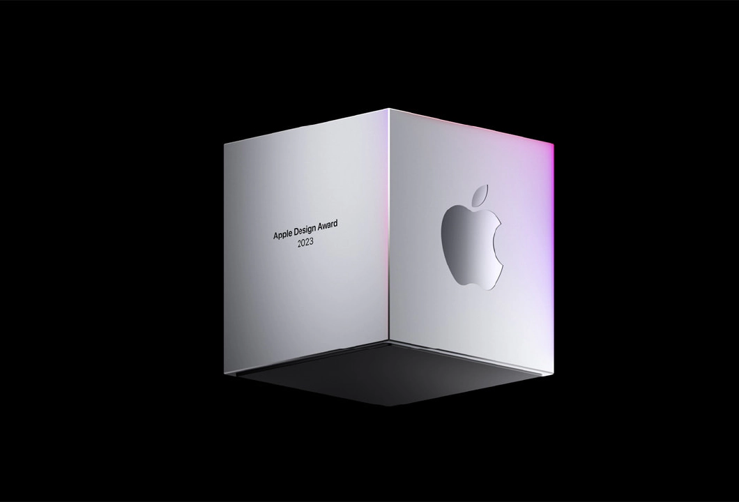 A silver three-dimensional cube floating against a black background, with the text Apple Design Awards 2023 on one face of the shape, and the Apple logo on another face of the shape.