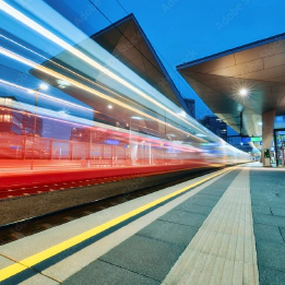 Photo of a red train speeding past a platform with a blur effect to convey movement. Photo of a red train speeding past a platform with a blur effect to convey movement.