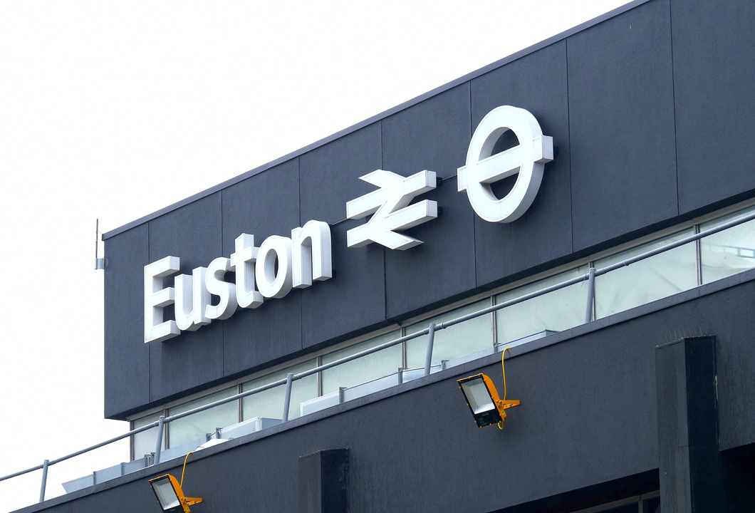 A white sign on a black background reading Euston from the Euston train station.
