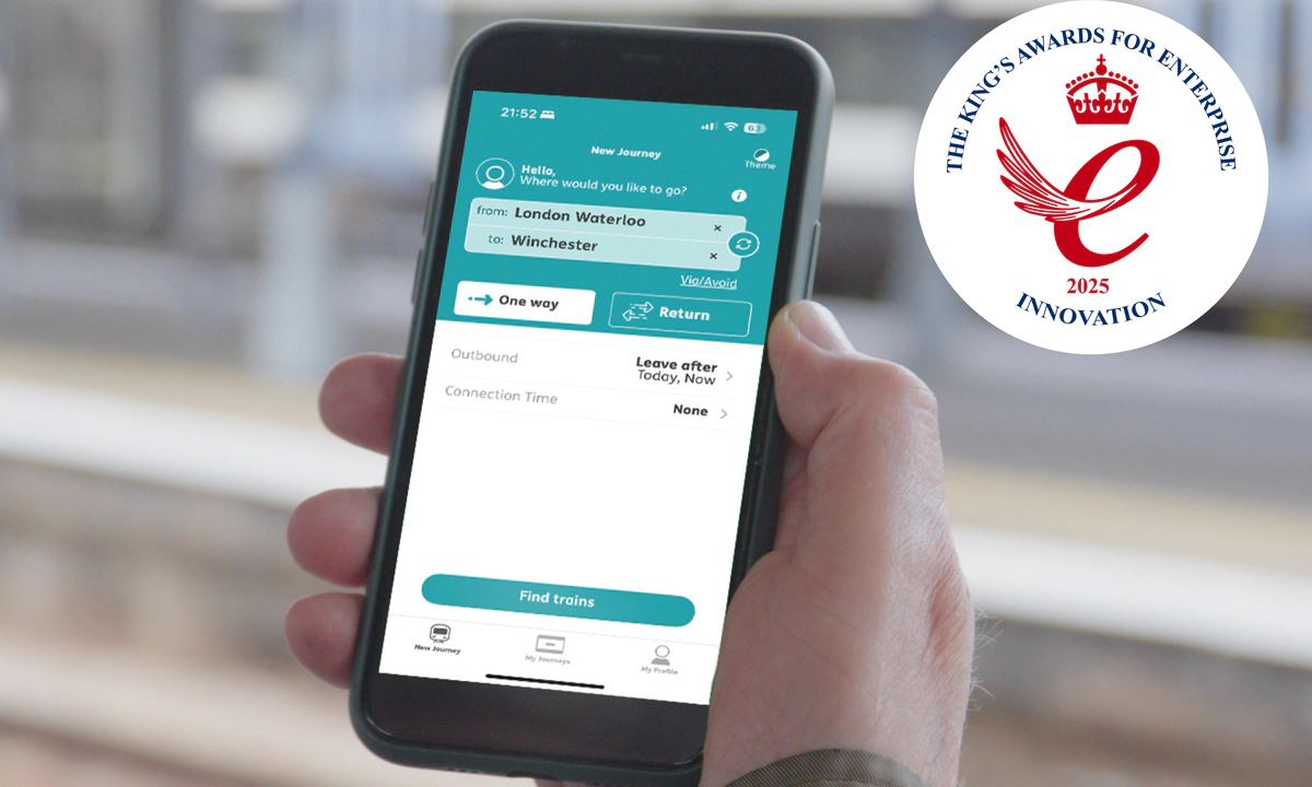 On the left, a teal background with Transreport logo in white and the King’s Awards for Enterprise 2025 Innovation emblem are displayed. On the right, a person uses the Passenger Assistance app on a smartphone to plan a train journey from London Waterloo to Winchester.
